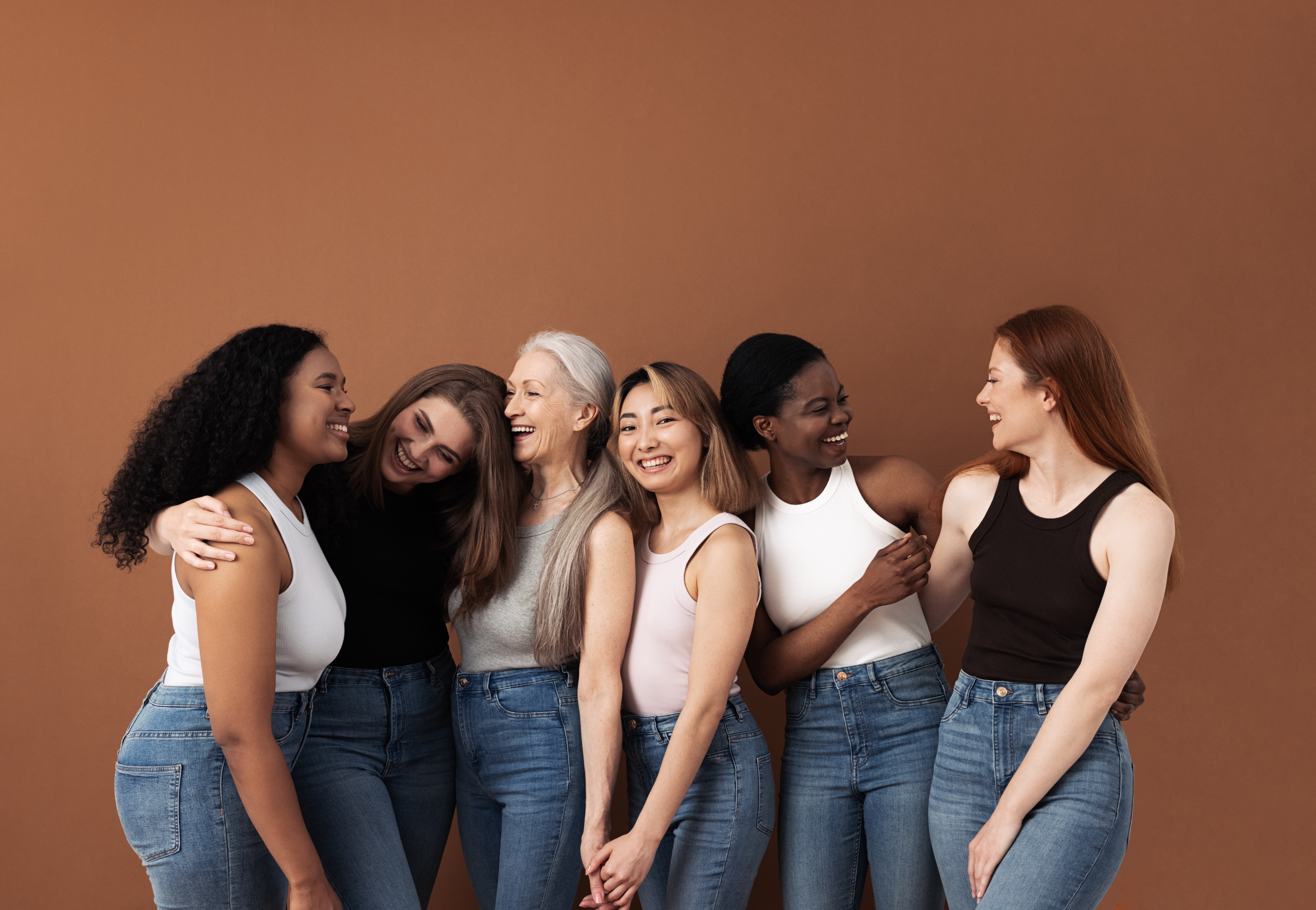 group of six breast augmentation patients standing together and laughing