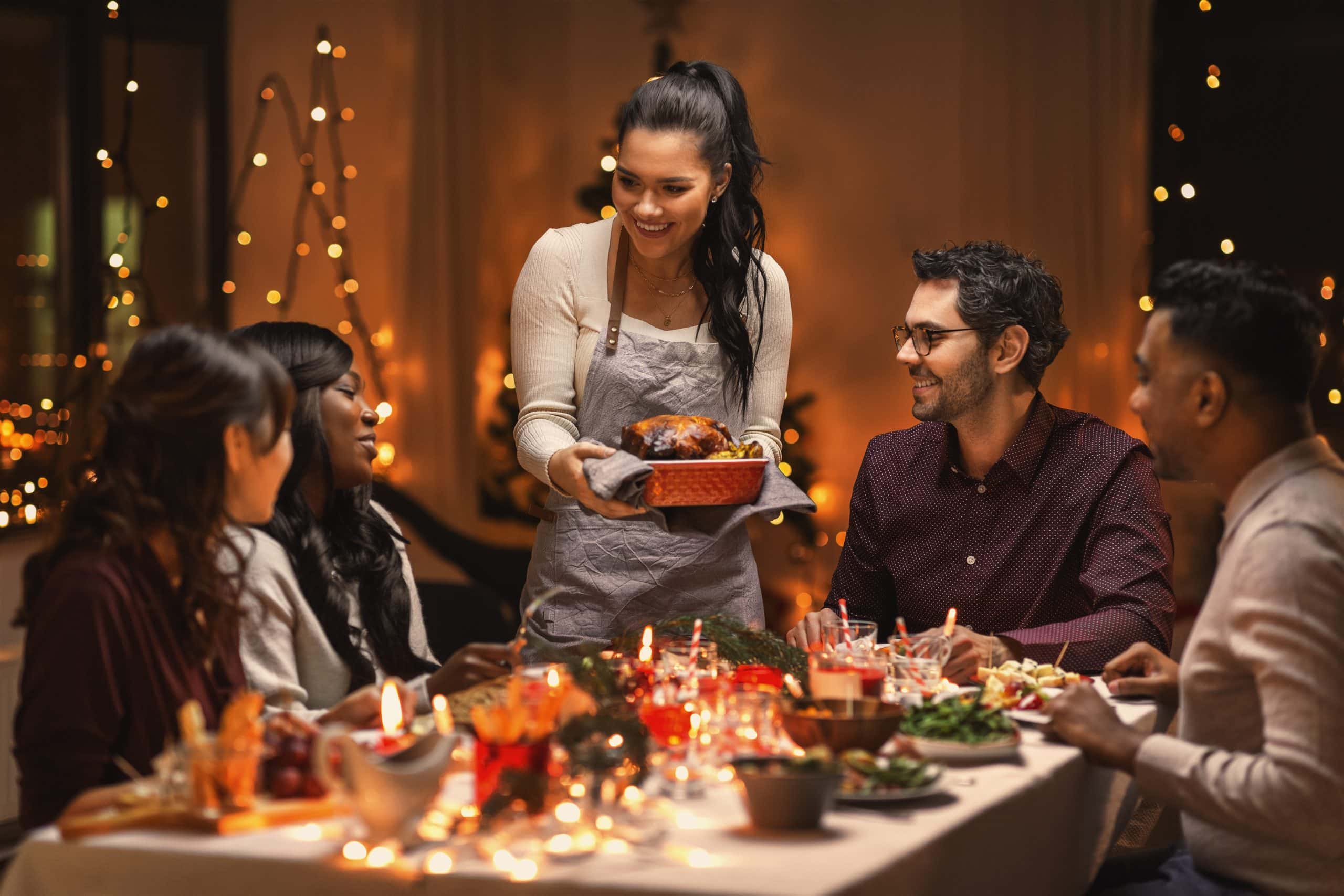 group of friends sitting at a table enjoying a holiday meal after body contouring