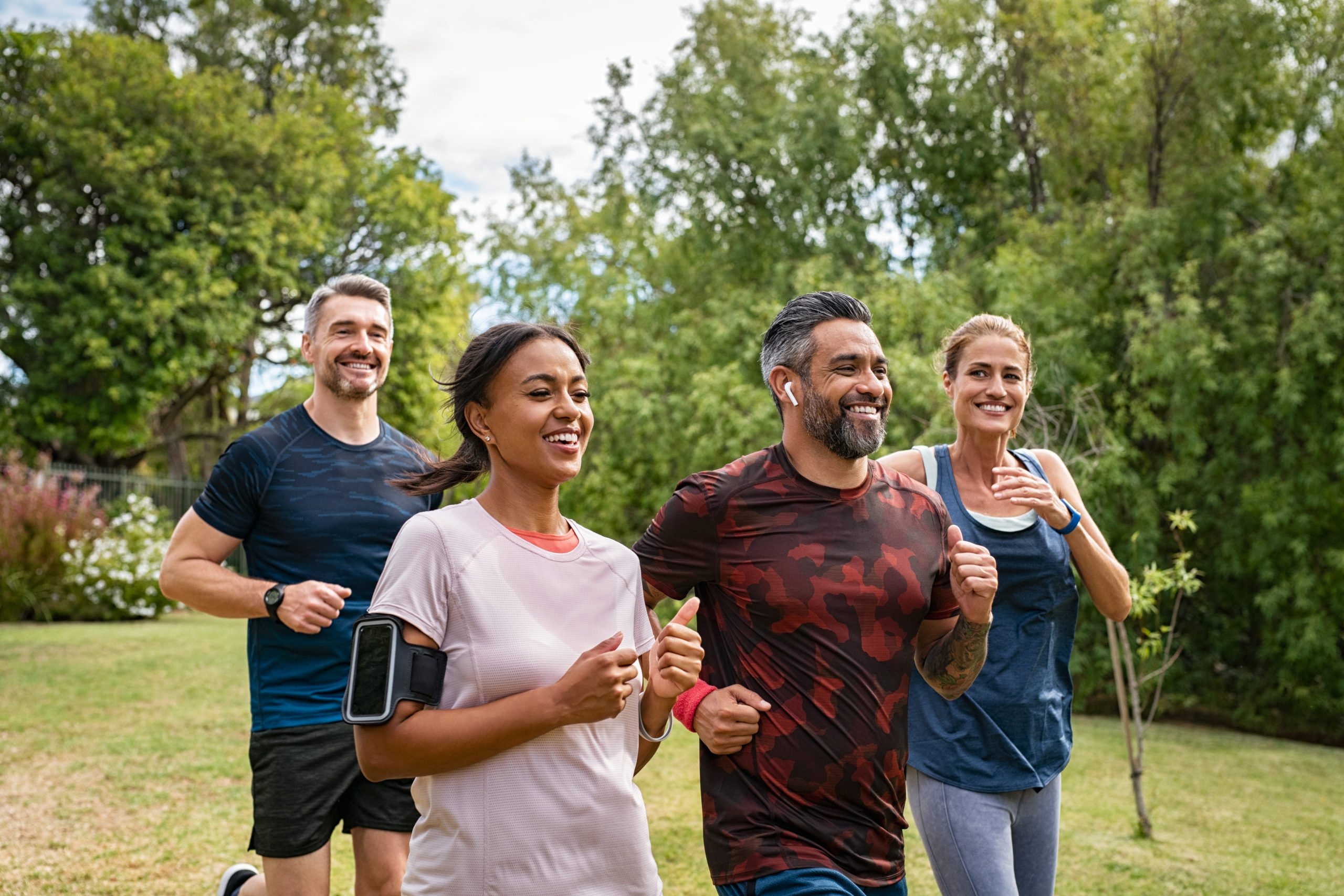 group of men and women jogging outside after a skin rejuvenating treatment