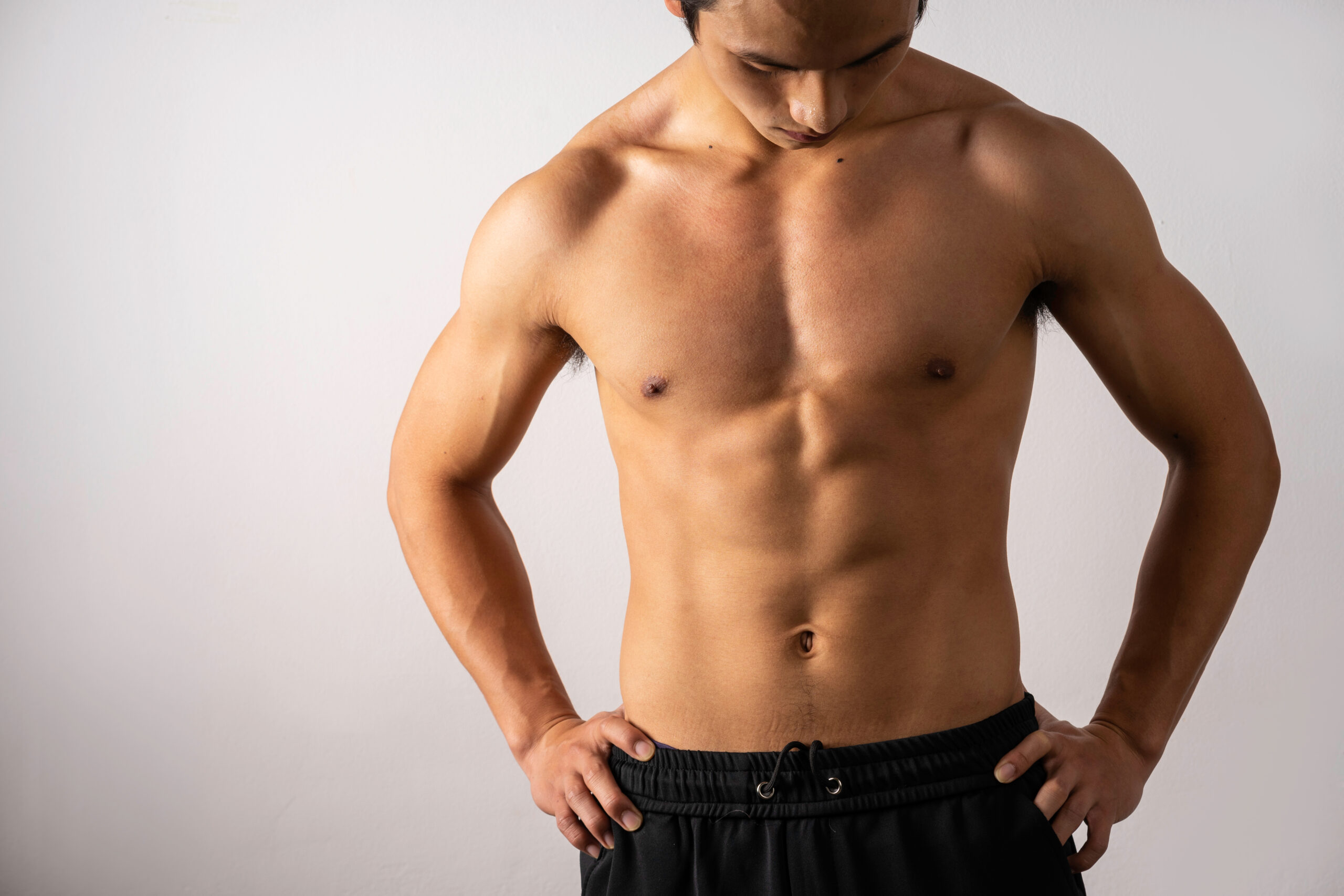 shirtless athletic man with defined muscles after body contouring