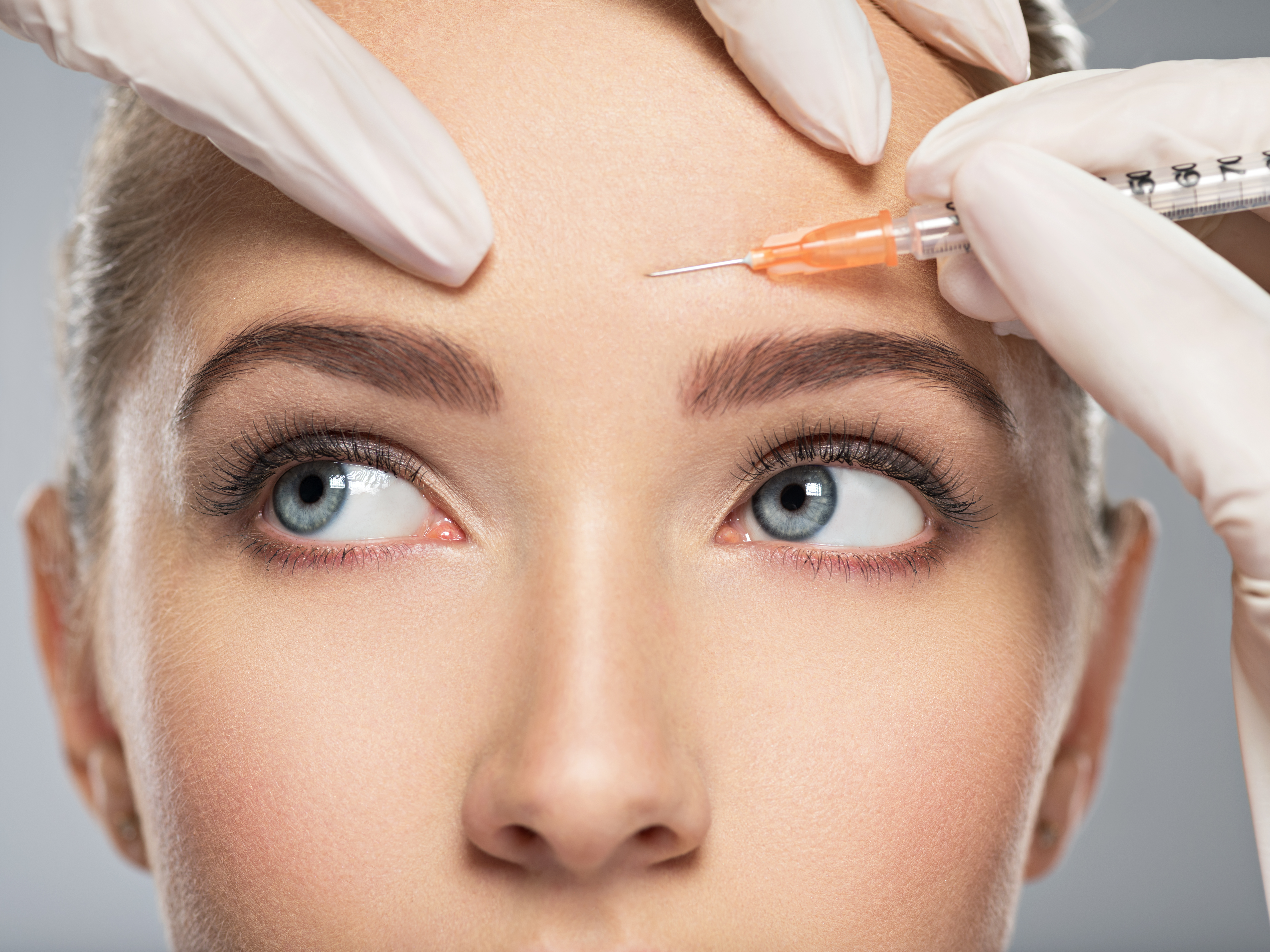 inquisitive woman receiving botox injections