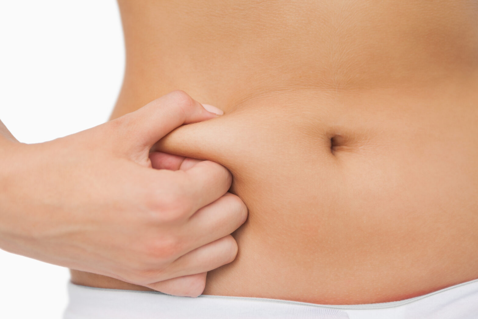 woman squeezing stomach fat