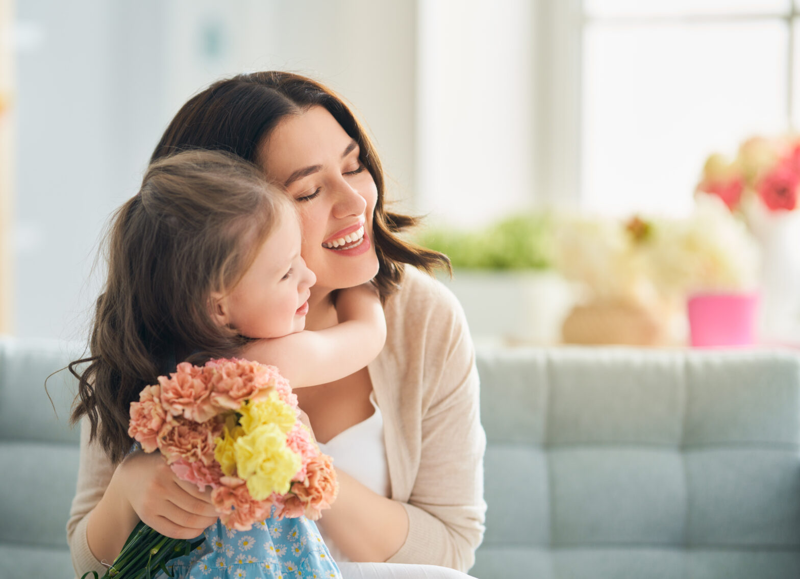 mom and daughter smiling together